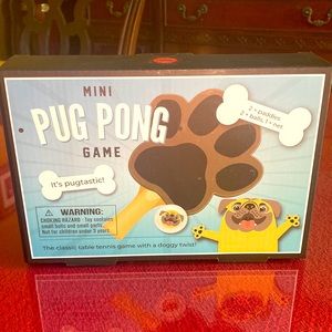 NWT mini pug pong game. Comes with 2,paddles, 2 balls & a net